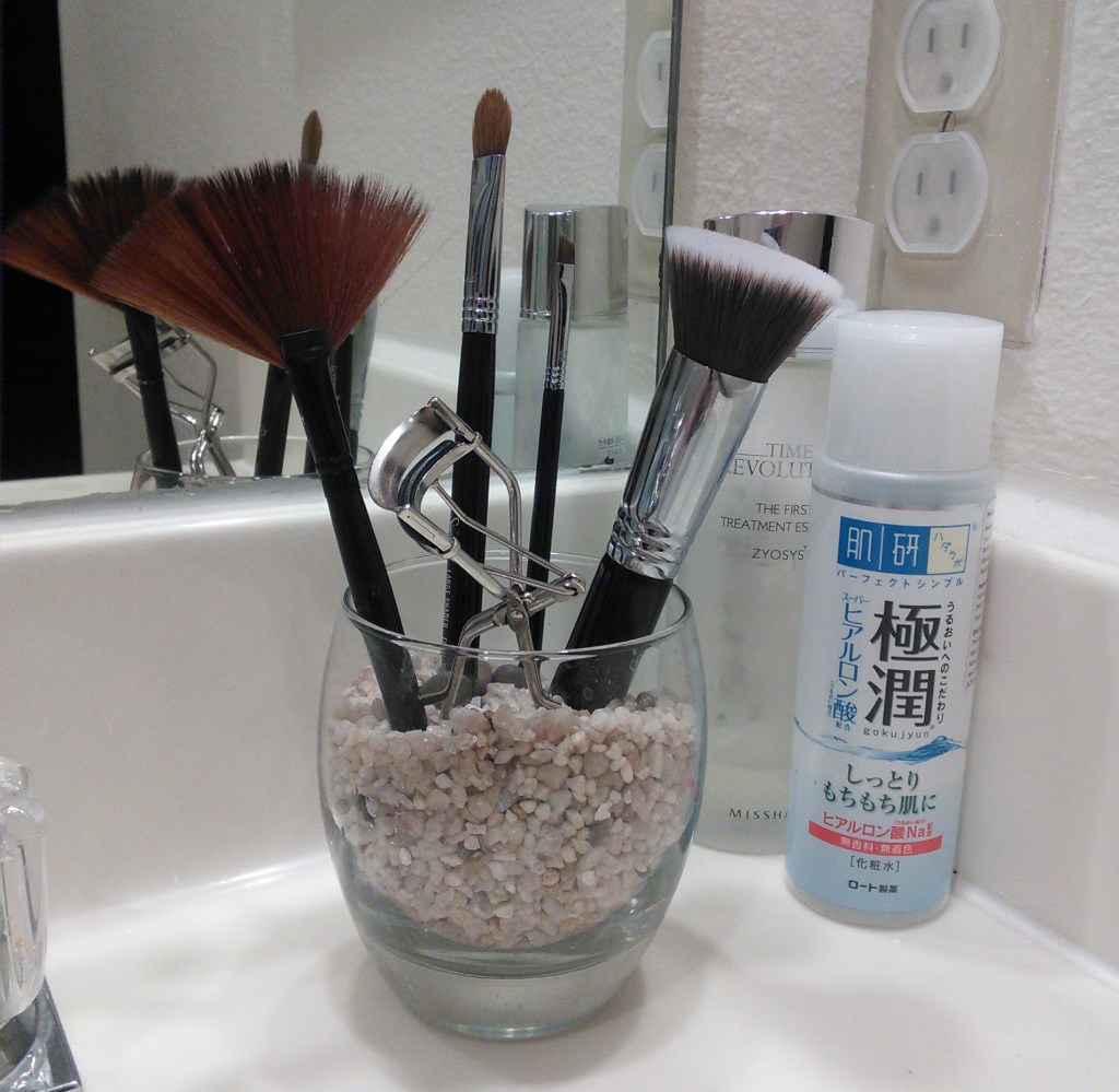 Makeup brushes and Shu Uemura eyelash curler.